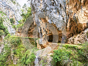 Hiking trail Cares Trail or Ruta del Cares along river Cares in cloudy spring day  near Cain, Picos de Europa National Park, p photo