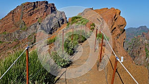 Hiking trail limited by ropes on rugged mountain edge near Pico do Areeiro on Maderia, Portugal.