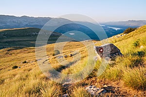 Hiking trail mark painted on rock. Landscape view from Sinjal or Dinara 1831 m mountain -the highest point of Croatia in the