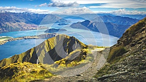 Hiking trail on mountain above lake landscape, scenic hike view over lake wanaka in new zealand, roys peak