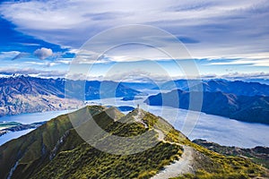 Hiking trail on mountain above lake landscape, scenic hike view over lake wanaka in new zealand, roys peak