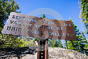 Hiking trail sign posted on the trail to Sentinel Dome, close to Glacier Point, showing points of interest and distances; Yosemite