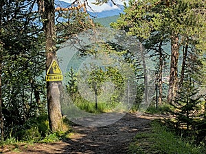 Hiking trail wit warning sign `Falaise`, french for cliff