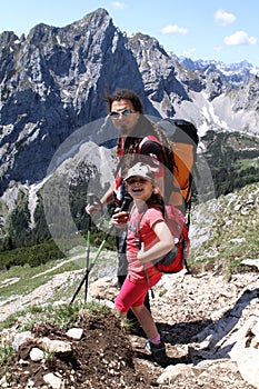 Hiking trekking child and father in the Alps