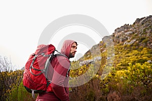 Hiking, trekking and man on mountain, nature and rock for outdoor adventure with backpack. Male person, athlete and