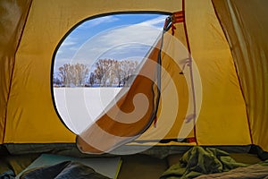 Hiking winter travel concept. View from tent - beautiful landscape of snow nature