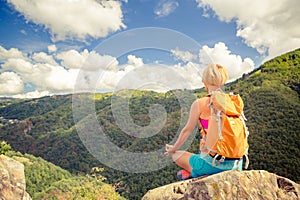 Hiking woman celebrating inspirational mountains landscape