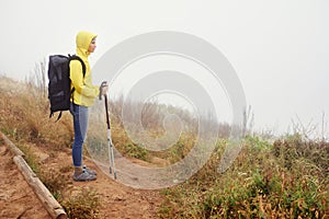 Hiking woman, fog and exercise for cardio, walking stick and activewear for fitness. Backpack, adventure or mountain