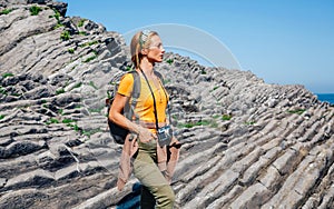 Hiking woman watching flysch rocks landscape