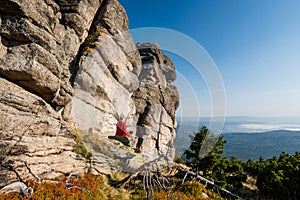 Hikings along tourist trails in the Karkonosze Mountain national park in Poland with the backpack on the back. Rock formation