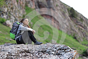 Hikker sitting contemplating views in the mountain photo