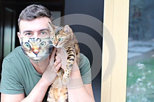 Hilarious man wearing his cat picture in protective face mask