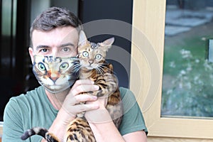 Hilarious man wearing his cat picture in protective face mask