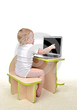 ÃÂ¡hild baby girl toddler sitting computer laptop pointing finget at display