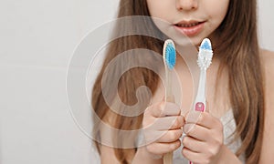 ÃÂ¡hild brushes teeth with bamboo brush.
