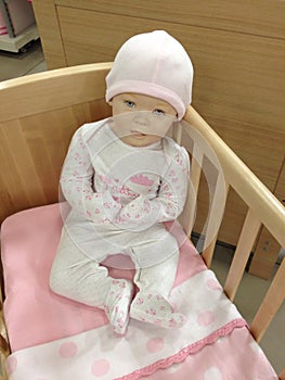 Ð¡hild mannequin sitting in a crib