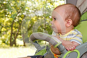 Ð¡hild in a stroller sunny day