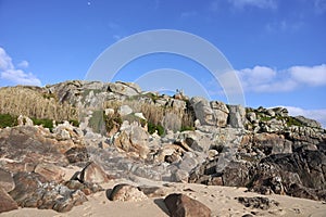 Hill of boulders with people on top photo