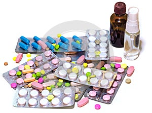 Hill of colorful pills and medicaments for all ills isolated on white