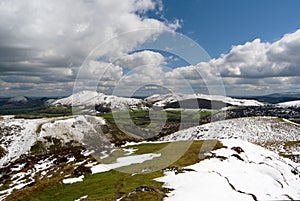 Hill of the Long Mynd, view on the Carding Mill Valley and Caer Caradoc, peaks under the snow, spring in the Shropshire Hills photo