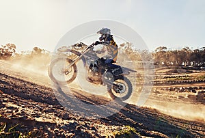 Hill, race and man on dirt bike in desert with adventure, adrenaline and speed in competition, Extreme sport, dust and