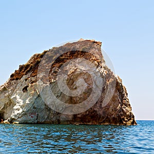 hill and rocks on the summertime beach in europe greece santorini island