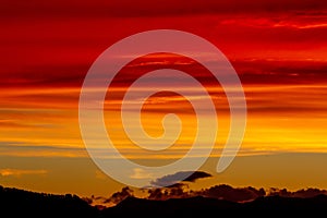 Hill silhouettes under a cloudy sky during a breathtaking sunset in Patagonia, Argentina