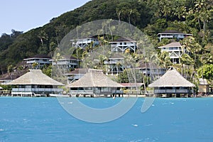 Hill slope by the sea and lodges on a slope. Polynesia.