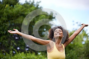 The hills are alive. a carefree and attractive young woman enjoying time in the outdoors.