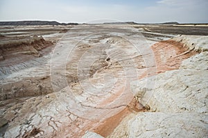 Hills of chalk and limestone and slopes of multi-colored mountains with weathering and washouts from water