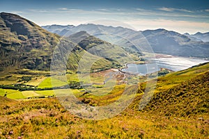 Hills and mountains under the beautiful light from within the clouds and the green hills West Highlands in Scotland, United