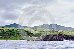 Hills of Sabtang Island with Lighthouse fronting the shore at, Batanes, Philippines