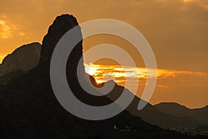 Hills silhouette in orange sunset light - nature mountains photo