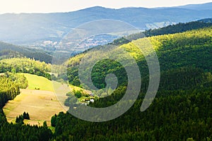 Hills and sunny valley in the Stone Mountains. Vast panorama of picturesque countryside landscape in Sudetes, Poland. Aerial view.