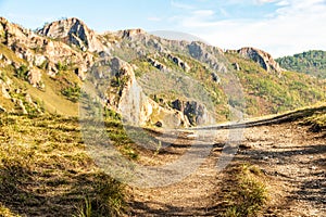 Hillside is crossed by hiking trail. Travel in mountains. Cross country running