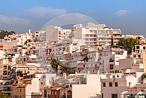 Hillside houses and apartments on a sunny, summer afternoon in the Costa Tropical town of La Herradura, Granada, Spain photo