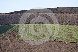 Hillside of recultivated landfill with gas pipes