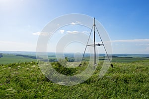 A hilltop triangulation map point. Landscape of countryside view