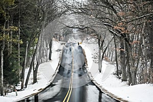 Hilly, Blacktopped Road with Snow and Trees photo