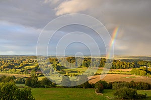 Hilly and hedging  landscape with rainbow. Hedging  landscape of north Germany by HÃ¼ttener Berge.