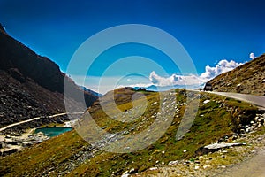 Hilly highway with green pasture and blue sky on the way to himalaya from the road,manali tourism Himachal leh ladakh, India