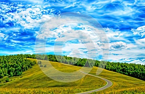 Hilly landscape with fields and blue sky.