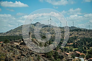 Hilly landscape with wind turbines on top