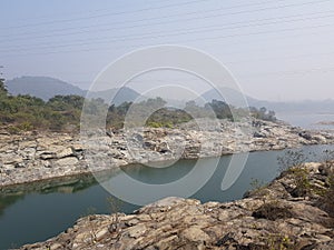 Hilly river flows to meets ocean photo