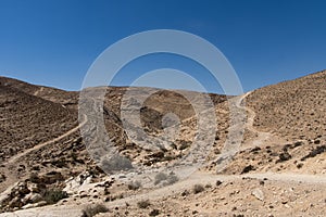 A hilly stone desert, with roads