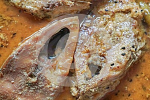 Hilsa fish pieces on a plate.