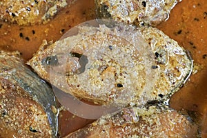 Hilsa fish pieces on a plate.