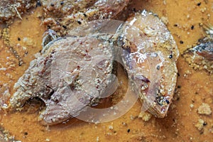 Hilsa fish pieces on a plate.