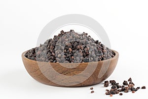 Himalayan black salt in a wooden bowl on a white background. Spices background.