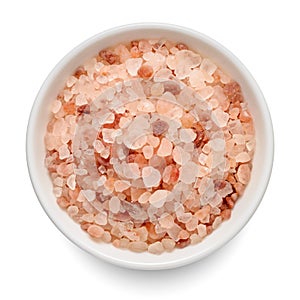 Himalayan coarse salt in white bowl isolated on white. Top view